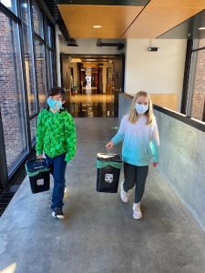 4th graders carrying compost buckets
