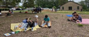 students reading books outdoors