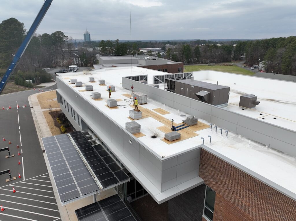 Top of Gateway building with pallets of cement blocks and solar panels